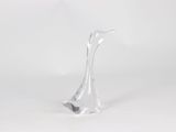 a glass sculpture of a bird on a white surface