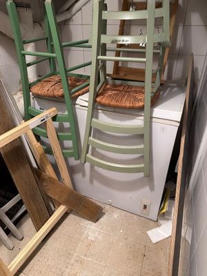 a stack of ladders sitting on top of a washing machine