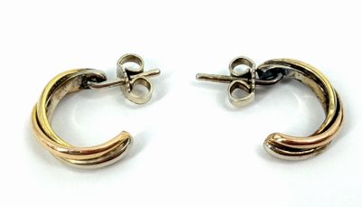 two tone gold and silver hoop earrings on a white background