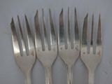 four forks with the word help written on them are sitting on a table