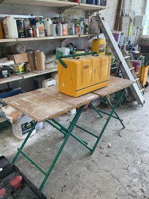 a workbench with a tool box on it in a garage