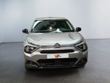 the front of a silver citrole parked in a showroom