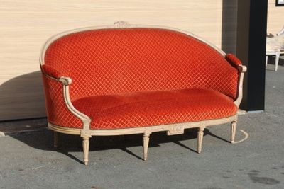 a red couch that is sitting in front of a wall