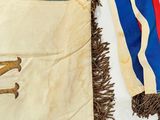 a flag with a horse on it hanging on a wall