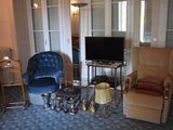 a living room with two chairs and a television in it