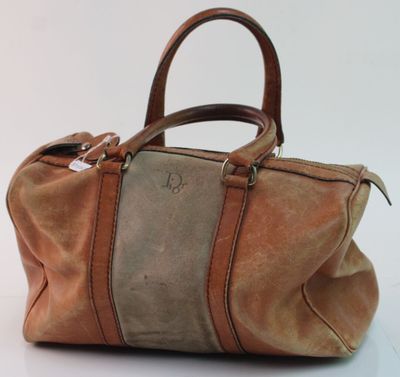 an image of a brown and tan handbag sitting on a white surface