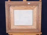 an image of a wooden easel with a painting on top of it
