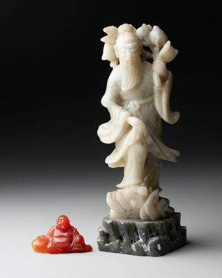 an image of a statue of a man holding a red object