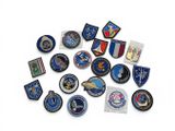 a lot of different military patches on a white surface