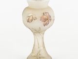 a glass vase with flowers painted on it on a white background