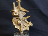 sculpture of a gold leaf on a black marble base