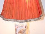a lamp that is on a table with a lamp shade on it