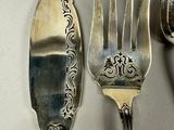 two forks and a spoon sitting on a table