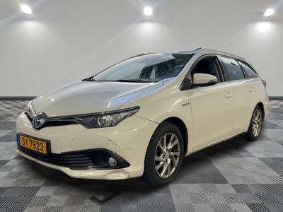 a white toyota auris parked on a checkered floor