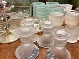 a lot of glass cups and saucers sitting on a table