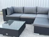 an image of a couch and coffee table in a yard