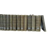 a lot of books that are stacked on a shelf