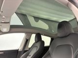 the interior of a car with a sunroof and black leather seats