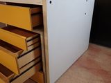 a yellow and white chest of drawers in a room