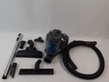 a close up of a vacuum cleaner and accessories on a white surface