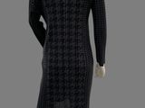 the mannequin is wearing a black dress and white shoes
