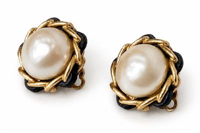 an image of a pair of pearl earrings on a white background