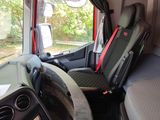 two seats in the back of a bus with a red seat belt