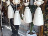 many lamps hanging from the ceiling in a room