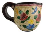 a coffee cup with a floral design on it