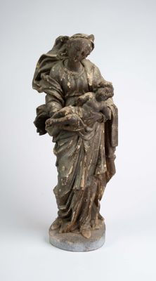 an old statue of a woman holding a baby in her arms