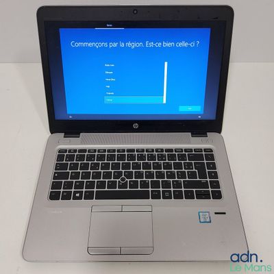 a laptop with a blue screen sitting on a table