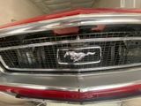 a close up of a car ' s front grill with a horse on it