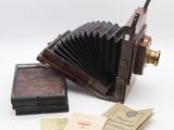an old camera and some old papers on the table