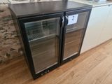 a refrigerator with two glass doors in a kitchen