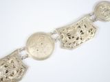 an image of a silver bracelet with four different designs on it