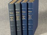 three blue books sitting on top of each other on a table