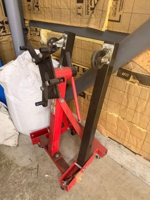 a picture of a red jack stands in front of a cardboard box