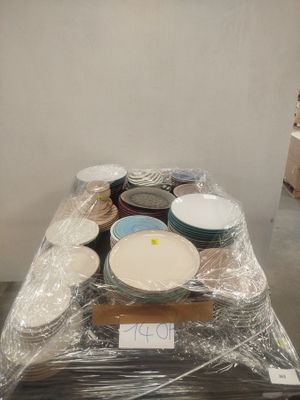 a table covered in plastic with bowls and plates on it