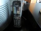 a cell phone sitting on top of a stack of plates