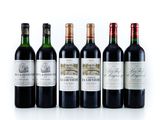 six bottles of wine are lined up in a row on a white surface
