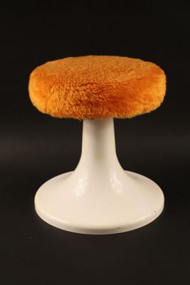 a small white stool with a fuzzy seat on it