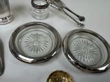 a lot of silver and glass items on the table