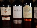 several bottles of wine are lined up on a table