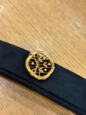 a close up of a black belt with a gold buckle on it