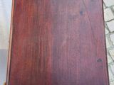 a close up of a small wooden table on a cobblestone floor