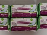 six boxes of organic sanitary pads sitting on top of a white counter