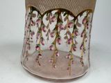 a glass vase with flowers on it sitting on a table