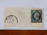 deux timbres posés sur un morceau de papier posé sur une table en bois