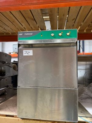 a silver refrigerator sitting on top of a pallet in a warehouse