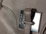 a close up of a metal buckle on a piece of luggage